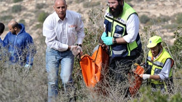 Israeli Zaka volunteers carry the body of U.S. citizen Christine Logan, on December 19, 2010 in Mata, Israel.  