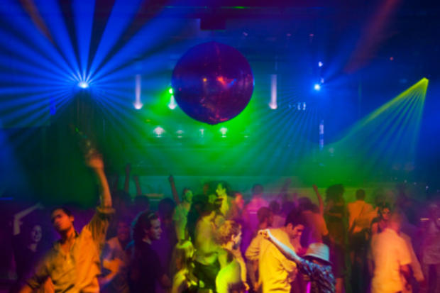People dancing at nightclub rave party 
