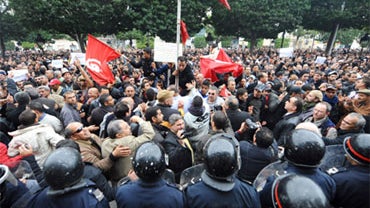 General secretary of PDP opposition political party Maya Jeridi (C) shouts slogans in front of the interior ministry in Habib Bourguiba avenue in Tunis, after Tunisian President Zine El Abidine Ben Ali's address to the nation on January 14, 2011.  