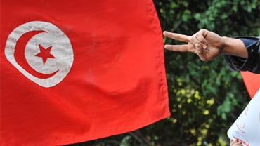 A man makes the V sign among groups of supporters as he demonstrates with Tunisians and Italian supporters in front of the Tunisian Embassy in central Rome, on January 15, 2011, after ousted Tunisian leader Zine El Abidine Ben Ali fled his homeland with h 