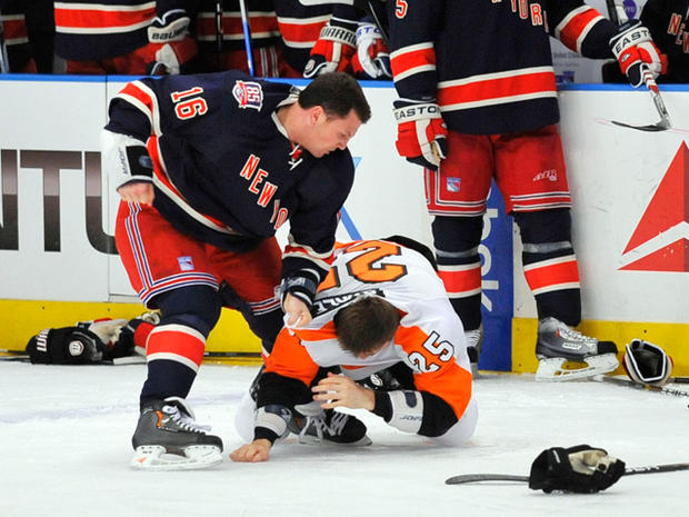 New York Rangers' Sean Avery, left, punches Philadelphia Flyers' Matt  Carle 