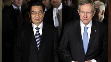 China's President Hu Jintao walks with Senate Majority Leader Harry Reid of Nev. on Capitol Hill in Washington, Thursday, Jan. 20, 2011. Senate Foreign Relations Committee Chairman Sen. John Kerry, D-Mass. is at center. (AP Photo/Carolyn Kaster) 