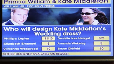 A video screen displays the betting odds for the designers of Kate Middleton's wedding dress at a bookmakers in London in this Nov. 26, 2010 file photo. 