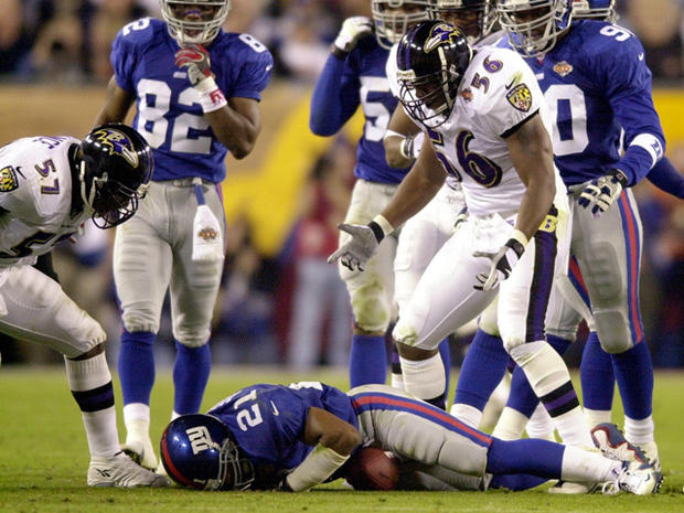 Tiki Barber of theGiants lies on the turf after being tackled  
