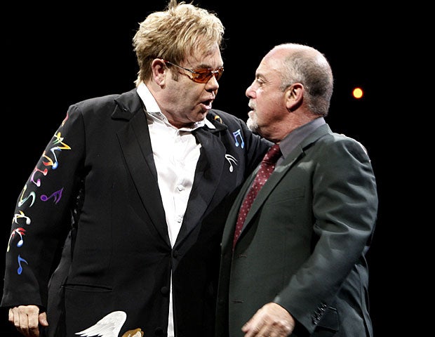 Sir Elton John, left, and Billy Joel perform onstage. 