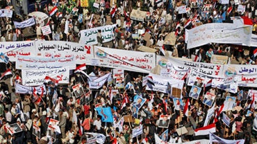 Supporters of Yemeni President Ali Abdullah Saleh hold banners and raise his portraits  