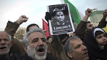 Hundreds of Iranian worshippers chant slogans as they hold a poster of Egyptian President Hosni Mubarak asking for his execution during an anti-Egyptian government protest following Friday prayers at Felestin (Palestine) square in Tehran on February 4, 20 