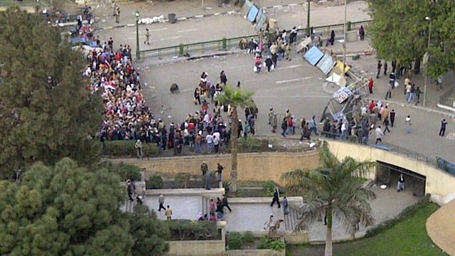 Protesters queue up to go through the military and protester checkpoints 