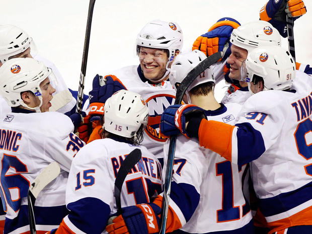 Islanders right wing Kyle Okposo celebrates with teammates 