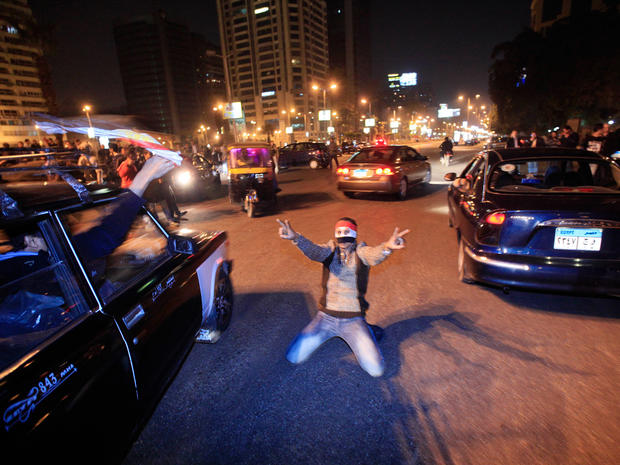An Egyptian reacts in the street after President Mubarak resigned  