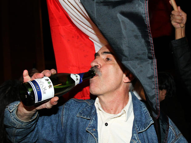 A Lebanese man drinks from a wine bottle during celebrations 
