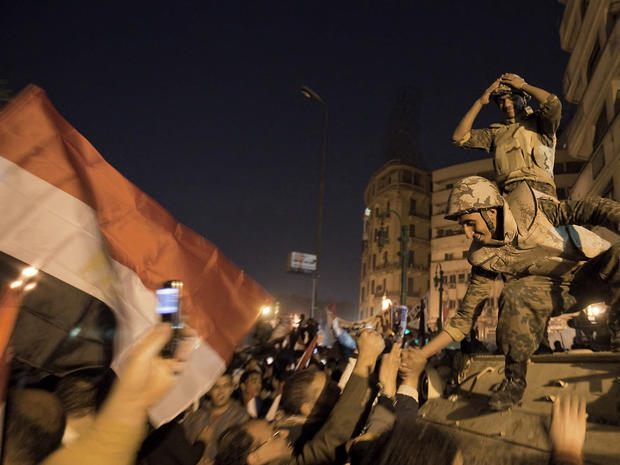 soldiers celebrate with anti-government protesters  