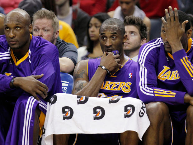 Lakers players sit on bench 