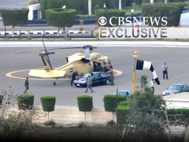 Hosni Mubarak waves as he boards a helicopter while leaving Cairo, Egypt 