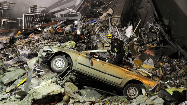 Rescue workers search for victims buried under the rubble 