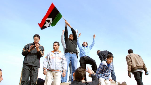 A Libyan protester holds up a sign against Libyan Leader Moammar Gadhafi during a demonstration. 