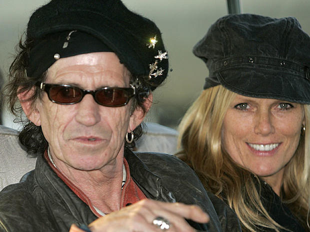 Rolling Stones guitar player Keith Richards (L), with his daughter Theodora, sits on a bus upon the Rolling Stones arrival at Shanghai Pudong International Airport, 06 April 2006. The Rolling Stones will finally play in China this weekend after a three-de 