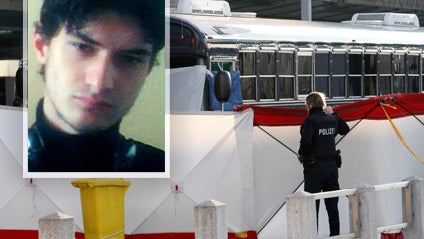Police officers errect a fence around a bus after a gunman fired shots at U.S. soldiers on the bus outside Frankfurt airport 