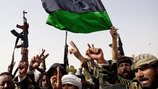 A Libyan man inspects the site of a massive explosion that occurred during the night in Benghazi, Libya 