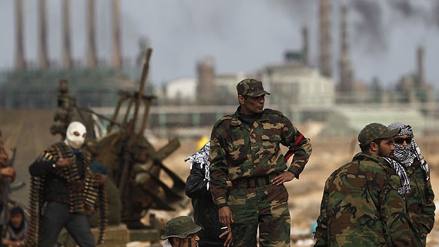 Libyan volunteers stand on the outskirts of the eastern town of Ras Lanouf, Libya, March 10, 2011. Government forces drove hundreds of rebels from a strategic oil port with rockets and tank shells on Thursday, significantly expanding Moammar Gadhafi's con 