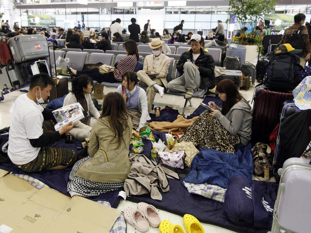 Passengers rest on the floor of the Narita International Airport, March 12, 2011. 