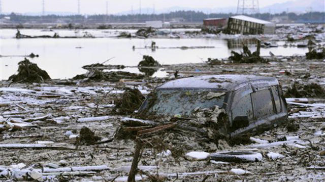 Residents walk through destruction in Sendai 