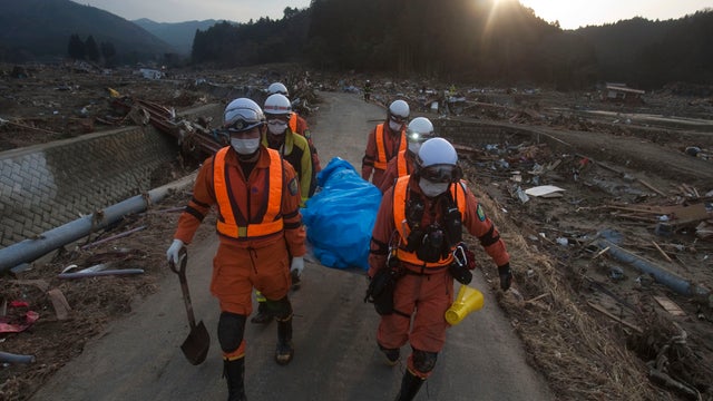 Workers search for survivors, and bodies, amid Japan quake rubble 