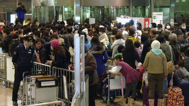 Chinese people crowd at a check-in counter at Niigata airport 