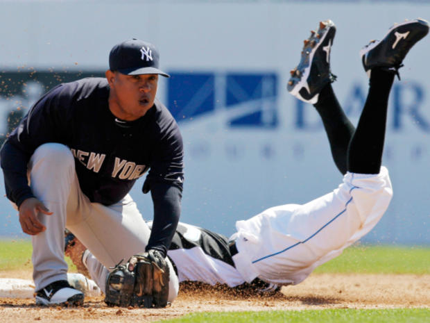 Scott Podsednik slides in behind the throw to New York Yankees second baseman Ronnie Belliard for a stolen base  