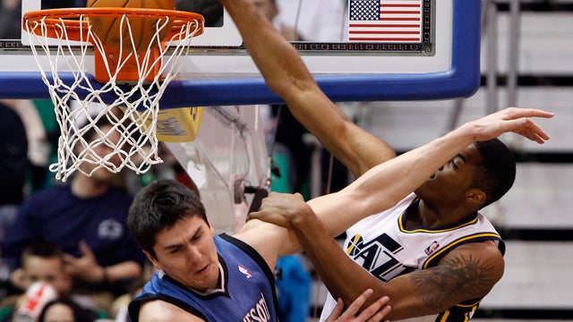 Derrick Favors dunks over Darko Milicic  