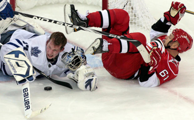 Hurricanes' Cory Stillman (61) collides with Maple Leafs goalie James Reimer  