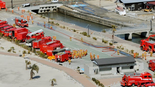 Fire trucks converge in preparation to spray water at the Fukushima Dai-ichi nuclear plant 
