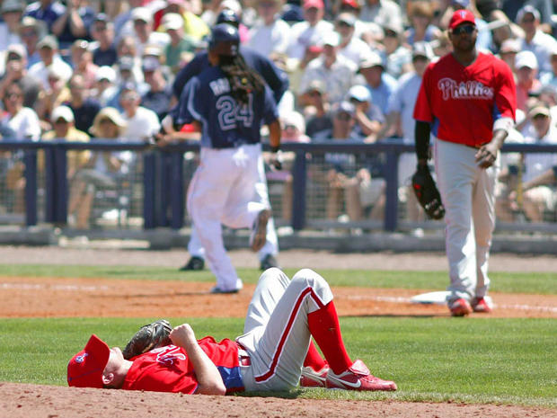 Philles pitcher Roy Oswalt lies on the ground 