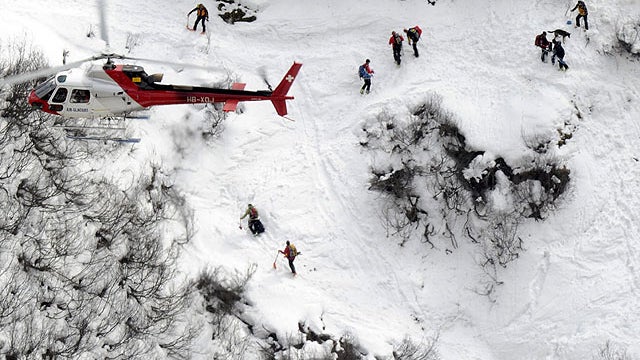 In this picture taken from a helicopter, rescue workers search for ten persons hit by an avalanche near Bourg-St-Pierre, southern Switzerland, March 26, 2011.  