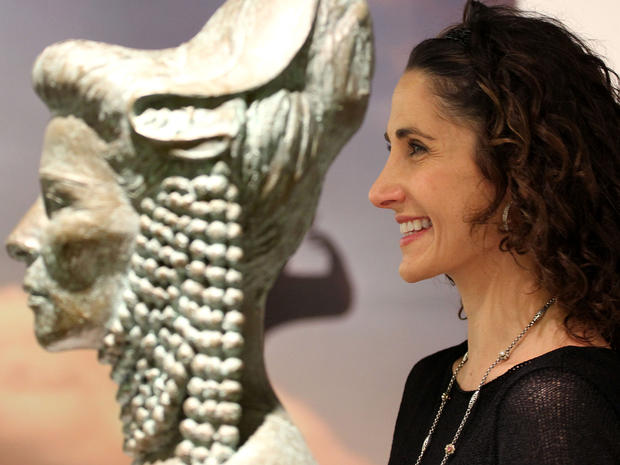 Melina Kanakaredes poses next to a bronze statue of Katherine Hepburn in Athens, Greece. 