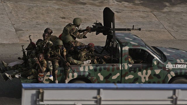 Unidentified troops drive past in the city of Abidjan, Ivory Coast, April 1, 2011. 