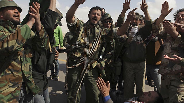Libyan rebels celebrate as they hear about air strikes at front line near Brega, Libya, April 1, 2011.  