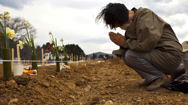 Relative pays her respects on April 8, 2011 in Yamamoto, Miyagi Prefecture, Japan to victim of March 11 mega-quake 