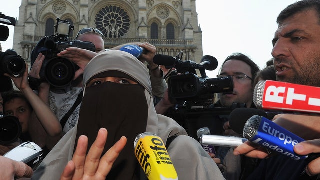 Kenza Drider addresses the media as she demonstrates against the ban of the 'niqab'  