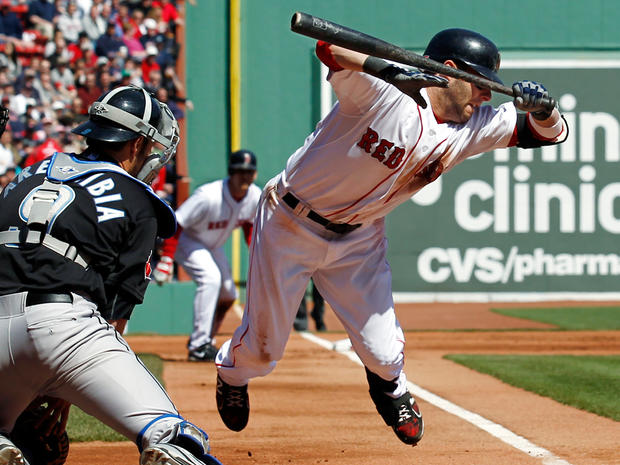 Dustin Pedroia jumps out of the way of a pitch 