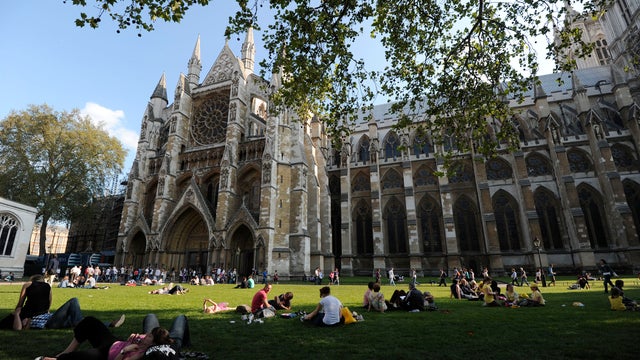 Tourists relax in the gardens outside Westminster Abbey on April 22, 2011, before the royal wedding between Britain's Prince William and his fiancee Kate Middleton at Westminster Abbey on April 29, 2011. 