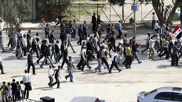 Syrian anti-government protesters march during a demonstration following Friday prayers near Damascus, Syria, April 22, 2011.  