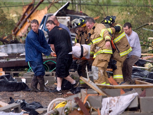 First responders carry an elderly woman away  