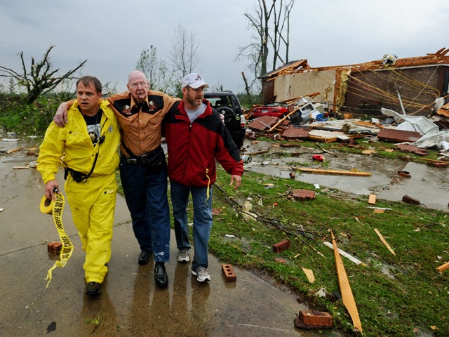Deputy Johnny Morell and Kirk Bowley escort John Wessinger from the remains of his home 