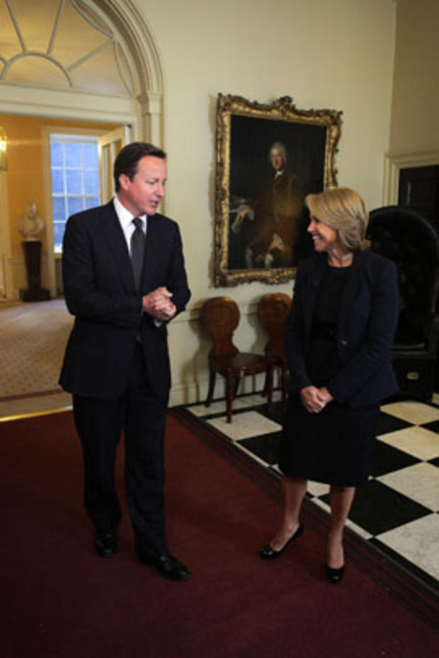 CBS Evening News anchor Katie Couric  shares  a laugh with British  Prime Minister David Cameron during an interview in london on April 28, 2011.   