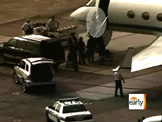 Ariz. Rep. Gabrielle Giffords (spotlighted) boards plane in Houston to fly to Florida April 27, 2011 to attend scheduled April 28 launch of space shuttle Endeavour with her husband, Capt. Mark Kelly, at the helm. It was to be Endeavour's last flight and t 