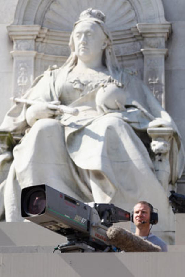 A cameraman films from the Queen Victoria Memorial in front of Buckingham Palace on April 27, 2011, in London. 