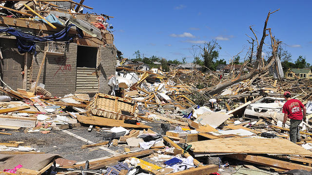 A man looks for personal items after a tornado struck Alabama.  