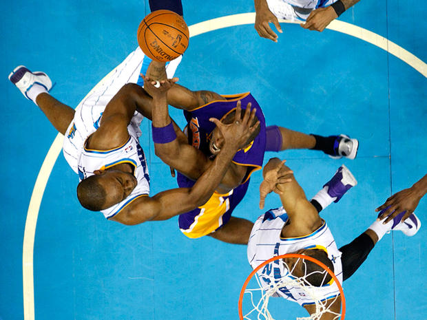 Kobe Bryant is fouled while driving to the basket 