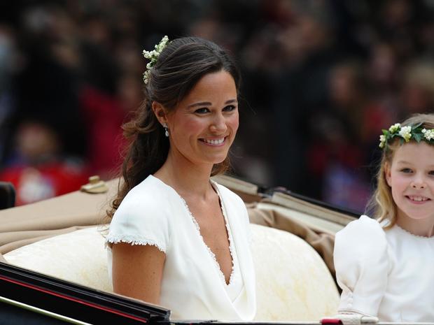 Maid of honour Philippa Middleton smiles as the travels in a Semi-State Landau in London after the wedding service for Britain's Prince William and Kate, Duchess of Cambridge, on April 29, 2011. AFP PHOTO / PAUL ELLIS (Photo credit should read PAUL ELLIS/AFP/Getty Images) 